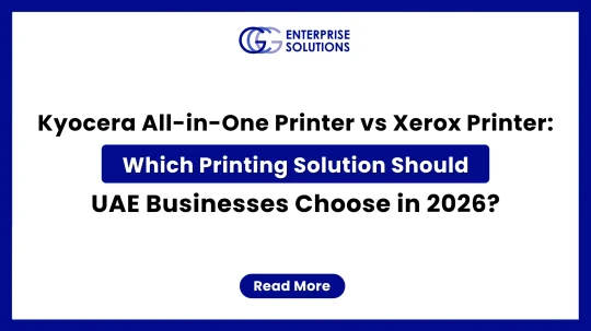 A clean corporate web banner with a solid blue outer border and white background, featuring the GCG Enterprise Solutions logo above text comparing Kyocera and Xerox all-in-one printers for UAE businesses in 2026.